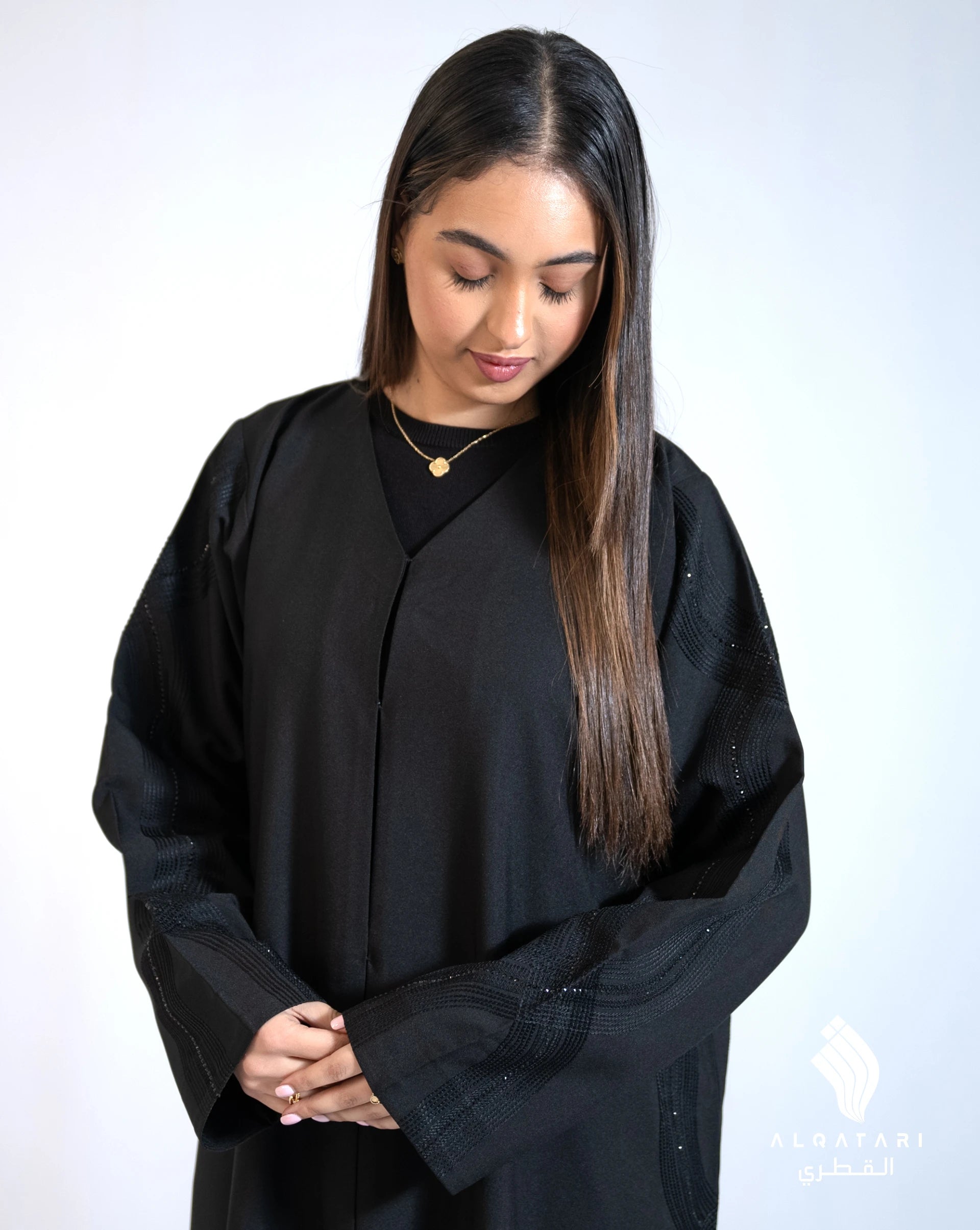 Front view of the abaya from Al Qatari Gallery highlighting the handcrafted side detailing and clean, graceful cut