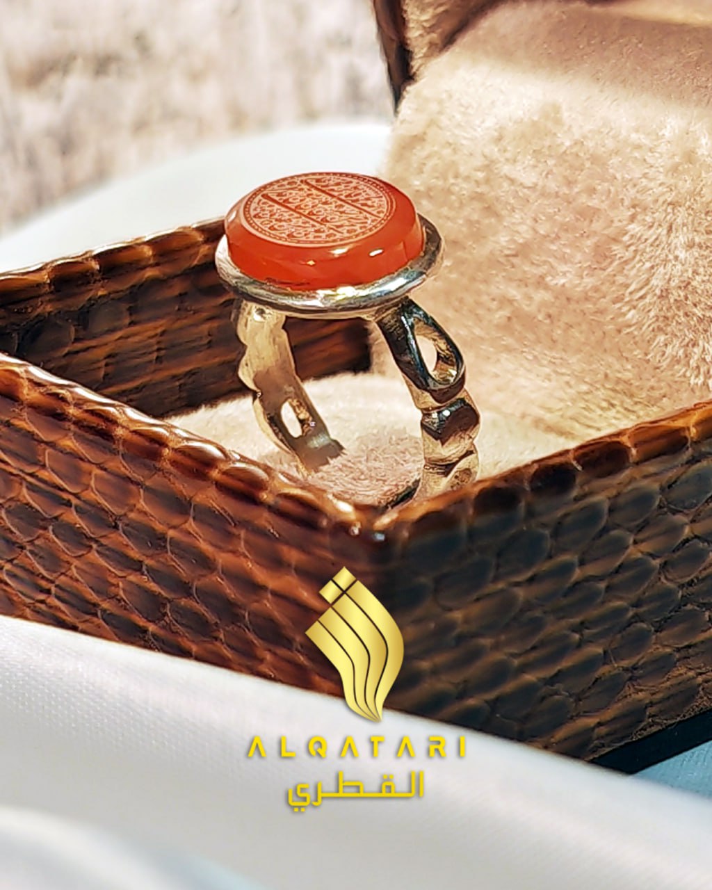 Angled view of Al Qatari red aqeeq agate Islamic ring in luxury packaging
