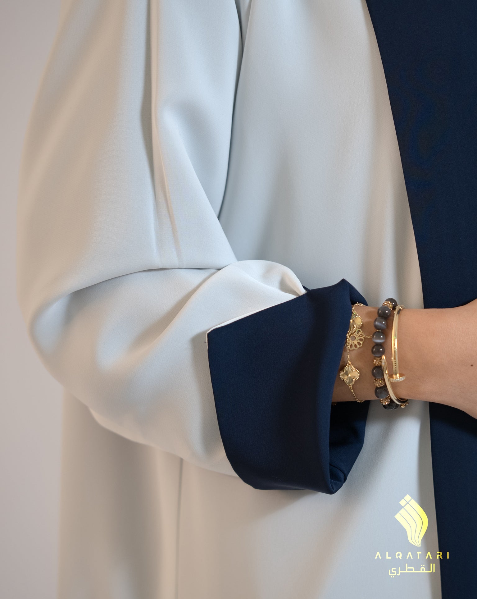 Close-up of sleeve showing inside contrast of the reversible abaya in navy and white, crafted from lightweight Nada fabric. Al Qatari Gallery
