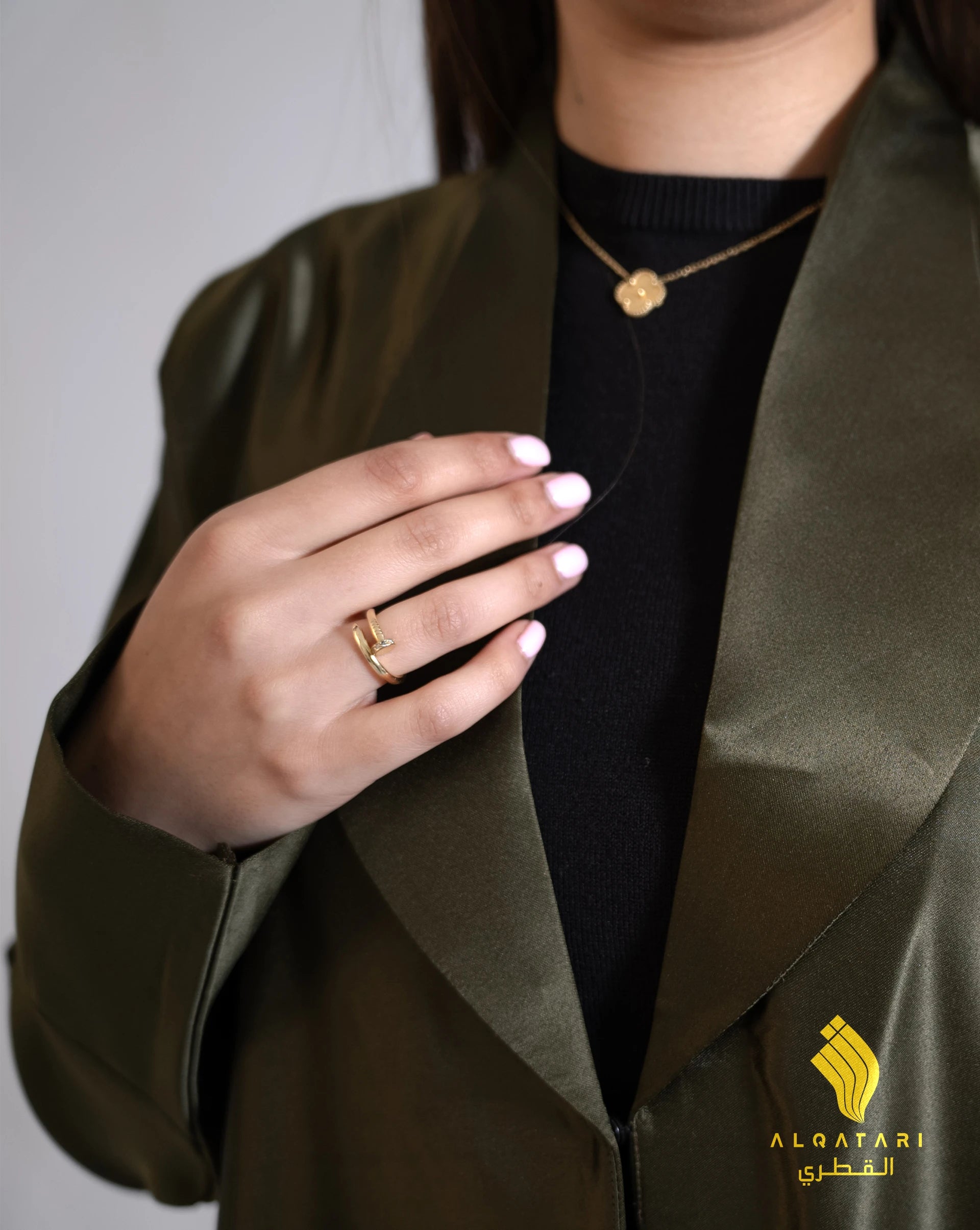 Model wearing a khaki green satin abaya with handwork from the Al Qatari Gallery collection – elegant evening modest wear in size 56.