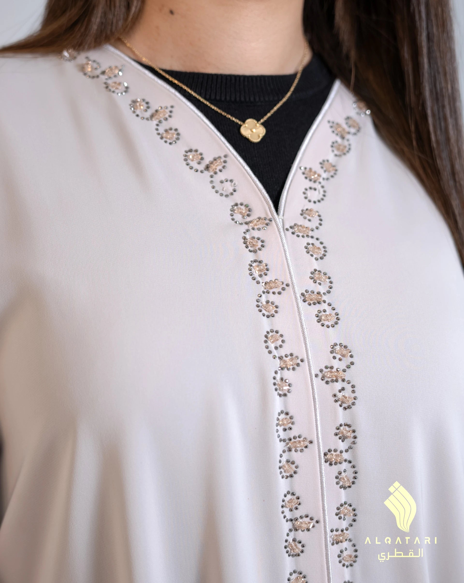 Neckline close-up highlighting the ornate handwork running along the front seam of the abaya. Al Qatari Gallery Luxury Wedding Abaya