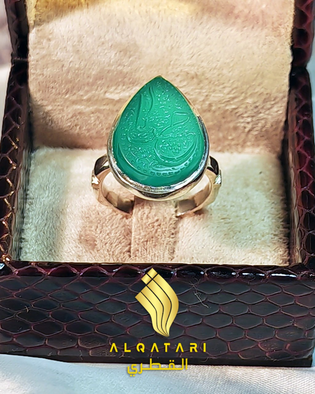 Overhead shot of Alqatari teardrop green gemstone ring with calligraphy detail "Ya Husain"