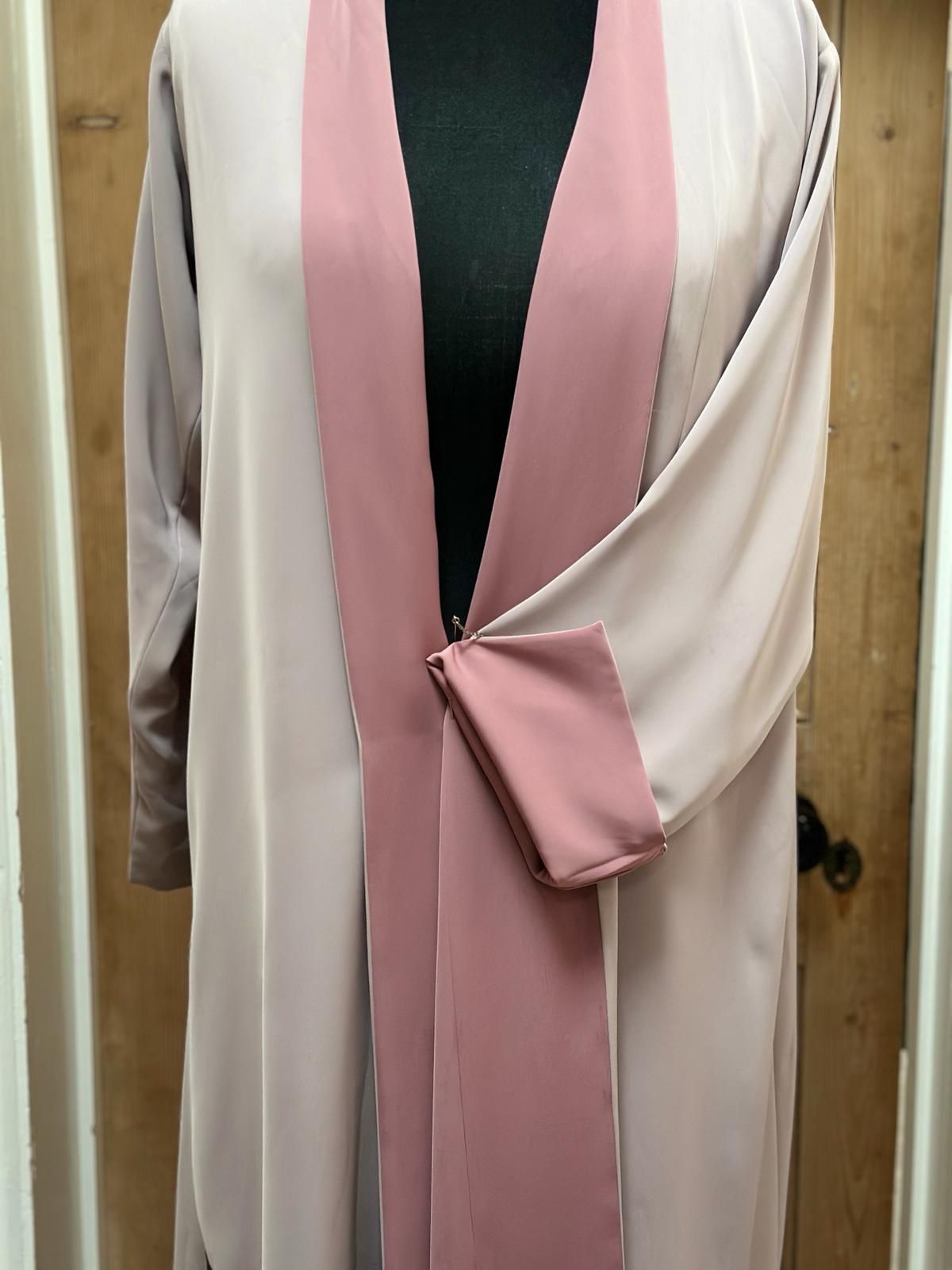 Pink and beige reversible abaya from Al Qatari Gallery on mannequin, showing both tones for versatile wear.