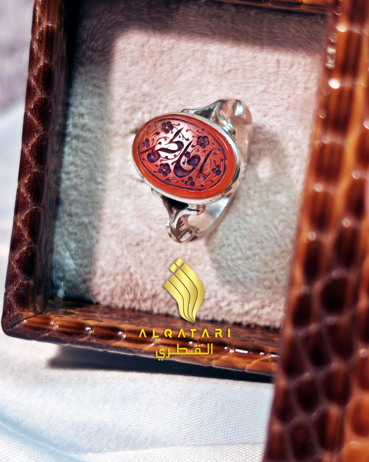 Sterling silver ring with oval red agate (aqeeq) stone featuring Arabic calligraphy "Ya Fatimah", displayed in a velvet ring box by Al Qatari Gallery