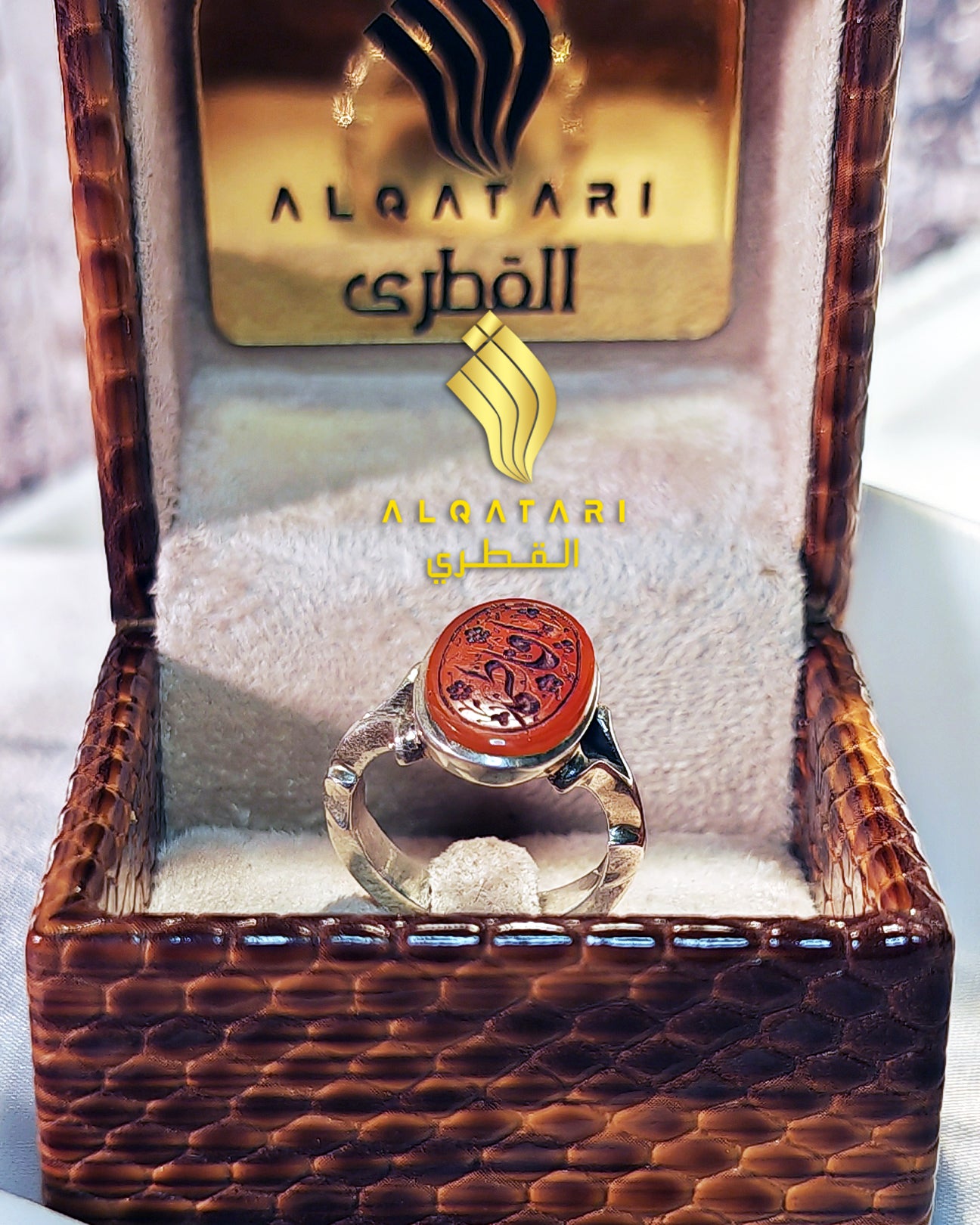 Sterling silver ring with oval red agate (aqeeq) stone featuring Arabic calligraphy "Ya Fatimah", displayed in a velvet ring box by Al Qatari Gallery